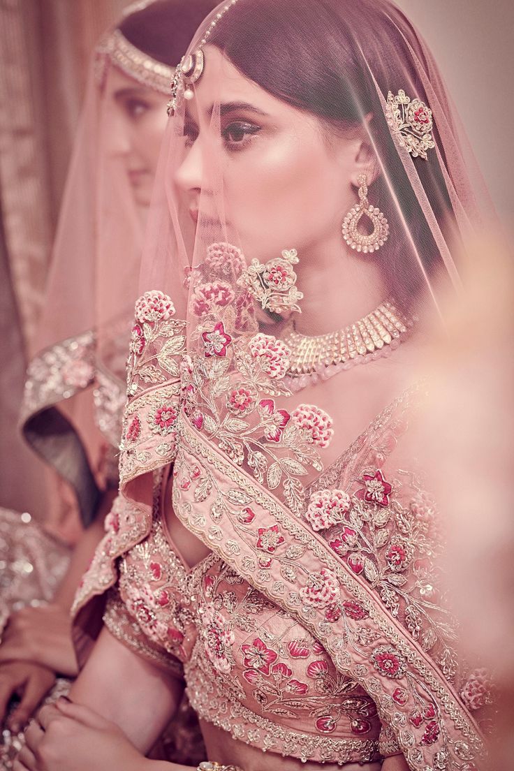 An elegant rose pink ensemble with heavy intricate detailing on the motifs and zardosi-stitch is spread across the entire expanse of the lehenga.From Bindani’s Tales of Navodha collection DELIVERY TIMEPlease allow 8-12 weeks for your outfit to arrive. FABRIC DETAILSRaw silk, Net Professional cleaning only. Rose Pink Lehenga, Lehenga Pink, Pink Bridal Lehenga, Lehenga And Blouse, Curated Outfit, Pink Lehenga, Pink Bridal, Silk Dupatta, Desi Fashion