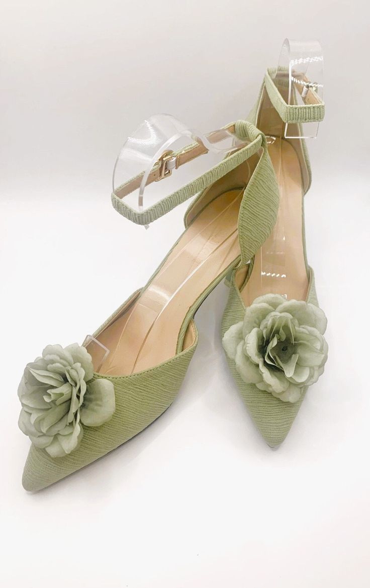 a pair of green shoes with flowers on them