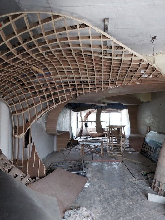 the inside of a building that is being renovated with wooden rafters on the ceiling