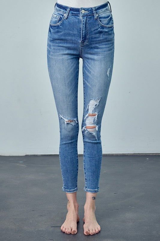 High Rise Ankle Skinny Jeans Embrace classic style with our High Rise Ankle Skinny Jeans. Crafted from a blend of cotton and spandex, these jeans offer a flattering high rise, a figure-hugging skinny fit, and a versatile ankle length. Perfect for a variety of looks. Key Features: High rise Skinny fit Ankle length Knee distress Stretch denim Details: Style: Casual Print/Pattern: Medium Silhouette: Skinny Fit: Skinny Embellishment: Knee Distress Length: Ankle-Length Closure: Button Closure Lining: Everyday Distressed Mid-rise Bottoms, Distressed Mid-rise Bottoms For Everyday, Mid-rise Distressed Bottoms For Everyday, Everyday Mid-rise Distressed Bottoms, Mid-rise Distressed Bottoms For Fall, Everyday Stretch Distressed Bottoms, Distressed Stretch Bottoms For Everyday, Stretch Distressed Bottoms For Everyday, Everyday Distressed Cropped Leg Bottoms