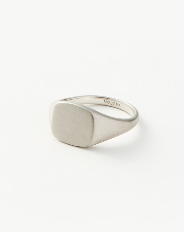 Mens Engravable Signet Ring | Sterling Silver. Handcrafted for Him. The Classic Signet Ring in Sterling Silver is Upgraded with a Brushed Finish and Rounded Edges, Plus It Can be Engraved on Top and on the Band's Outer Sides. Pair with a Chunky Chain Bracelet for a Statement Look. Please Note: Engraving Items May Take 7-10 Working Days to Process. Metal: Rhodium Plated on Recycled Sterling Silver Dimensions: 12. 5mm X 11. 5mm Weight: 7. 5g Product Code: Mj-S-R4-Ns Silver Engraved Metal Signet Ring, Silver Platinum Polished Signet Ring, Silver Sterling Silver Signet Ring, Tarnish Resistant, Silver Stainless Steel Signet Ring With Polished Finish, Formal Sterling Silver Signet Ring With Hallmarks, Double Chain Necklace, Gold And Silver Rings, Demi Fine Jewelry, Gold Price