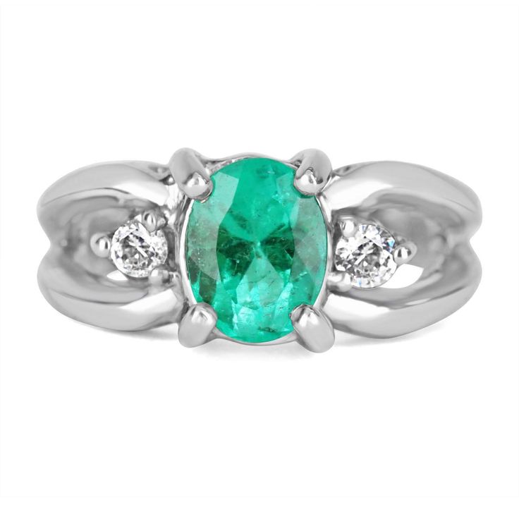 Displayed is a Colombian emerald and diamond ladies ring. Perfectly handcrafted in solid 14K white gold, this opulent ring features a bright, green Colombian emerald oval that is set in a secure four prong setting. On either side of the center stone are large brilliant round diamonds are also prong set. A beautiful split shank adds width to the ring. A perfect gift for someone you love or even for yourself! Metal Purity: 14K White Gold Weight: 6.8 grams Setting Style: Prong Main Stone: Colombian Oval Emerald Ring With Prong Setting In Platinum, Oval Platinum Emerald Ring With Prong Setting, Classic Oval Diamond Ring For May Birthstone, Oval Emerald Ring With Diamond Accents For Formal, Oval Solitaire Diamond Ring For May Birthstone, Oval Emerald Ring In White Gold With Diamond, Formal Oval Cluster Ring With Solitaire, Anniversary Oval Link Ring With Polished Finish, Oval Emerald Ring With Diamond Center Stone