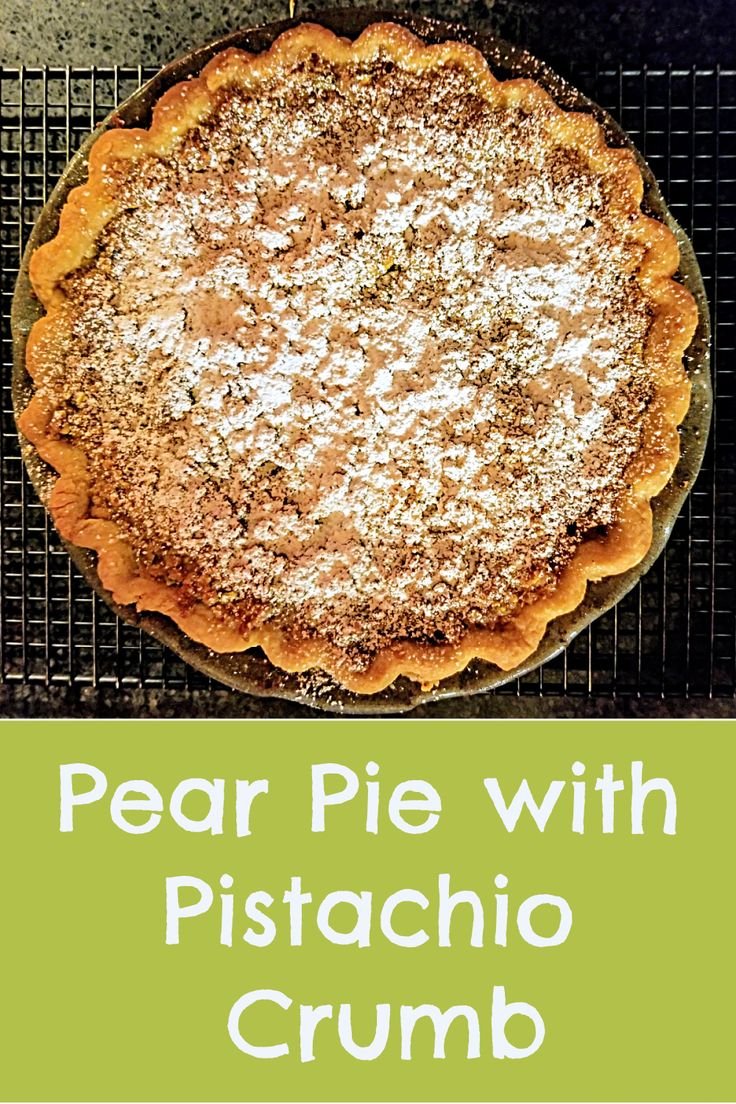 a pie with pistachio crumb on it sitting on top of a cooling rack