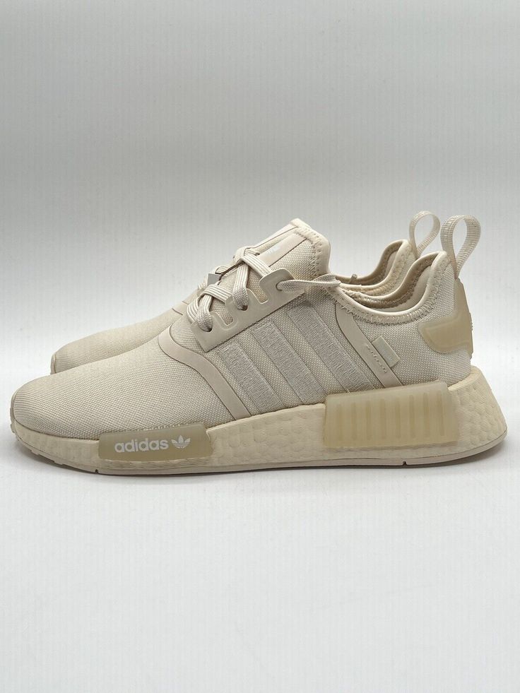 Elevate your sneaker game with these Adidas Women's NMD R1 Originals in size 7 and the color tan. The stylish design is perfect for athletic activities or casual wear. The shoes are made by the well-known brand Adidas and belong to the popular NMD product line. These sneakers feature a beige color and are specifically designed for women. The model is Adidas NMD R1 and they are perfect for those looking for a comfortable yet stylish pair of shoes. These sneakers are a size 7 and a UK shoe size of 5.5. Get ready to turn heads with these fashionable Adidas NMD R1 sneakers. Womens Nmd R1, Adidas Nmd R1, Dad Shoes, Nmd R1, Sneaker Games, Adidas Nmd, Beige Color, Stylish Design, Adidas Women