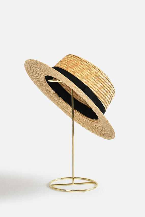 Bring classically chic flair to your summer look with the Abella Classic French Boater Hat. This classic French accessory is made from breathable straw and designed with an adjustable pull string for the perfect fit. You'll love the elegant aesthetic this piece adds to any ensemble.Head circumference: 55.5cm (designed with adjustable pull string for the perfect fit)Your purchase can also be made at:www.enbelleepoque.com Black Paper Straw Hat For Spring, Elegant Straw Hat For Spring Picnic, Adjustable Straw Boater Hat For Picnic, Adjustable Straw Boater Hat For Picnics, Summer Straw Boater Hat For Picnic, Elegant Spring Hats For Picnic, Adjustable Panama Hat For Summer Picnic, Elegant Vacation Straw Hat Made Of Paper Straw, Elegant Paper Straw Hat For Vacation