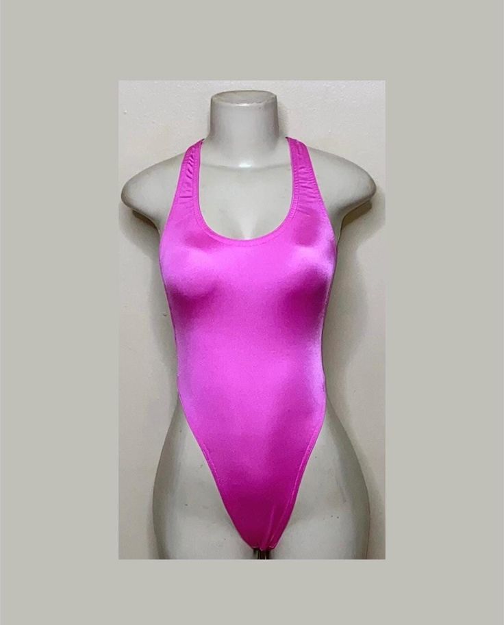 Welcome to my shop Let's Make Money Together 💕 DETAILS  * Handmade Item  * Materials: Nylon, Shiny Spandex * Full Bodysuit  * Never used  DESCRIPTION  * Thong Bodysuit  * Deep Pink Spandex * 4 way stretch Fabric * Mannequin is wearing XS/Small (may choose sizing at checkout)  SHIPPING  My current shipping turnaround is really quick 1 to 2 days  RETURNS & EXCHANGES  No refunds or exchanges if you have any issues with your purchase please feel free to reach me personally. I can accommodate on you Stretch One-piece Leotard For Club, Stretch One-piece Club Leotard, Fitted T-back Party Leotard, Dancewear Bodysuit For Parties, Solid Color Dancewear Bodysuit For Party, Summer Dance Bodysuit With High Stretch, Summer Dance Bodysuit With Stretch, High Stretch Bodysuit For Summer Dance, Fitted One-piece Leotard For Club