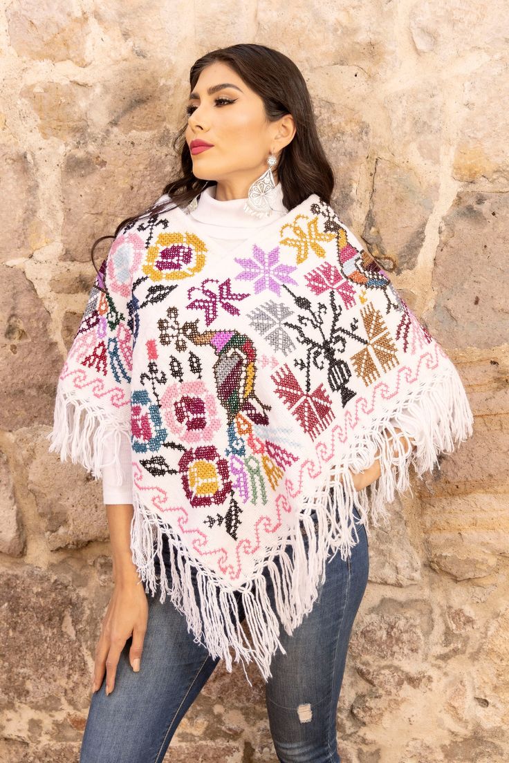 This beautiful Traditional  Poncho is completely unique in both design and embroidery. It has a beautiful embroidered Peacock Design.  It is Hand embroidered by Cross Stitch with details in cotton made on a loom.  THE COLORS ON THE EMBROIDERY ALWAYS VARY. It comes in one size which fits sizes Small, Medium, Large and  Extra Large. More styles available here: https://www.etsy.com/es/shop/SoleiEthnic?ref=seller-platform-mcnav&section_id=25348614 Traditional Poncho With Floral Embroidery, Winter Festival Embroidered Poncho, Bohemian Multicolor Shawl With Embroidered Border, Traditional Embroidered Winter Poncho, Bohemian Embroidered Festival Poncho, Traditional Embroidered Poncho For Winter, Folk Style Poncho With Floral Embroidery, Festival Poncho With Multicolor Floral Embroidery, One Size Embroidered Poncho For Festivals