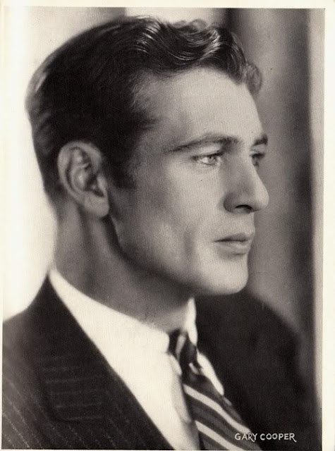 an old photo of a man in a suit and tie looking off to the side