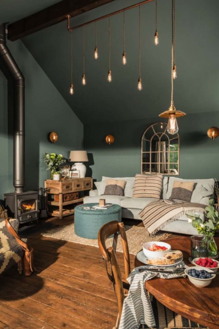 a living room filled with furniture and a wood burning stove in the middle of it