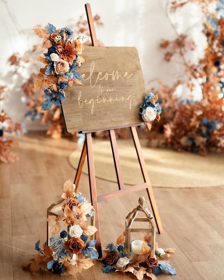 a wooden easel with flowers on it and a sign that says welcome to wedding