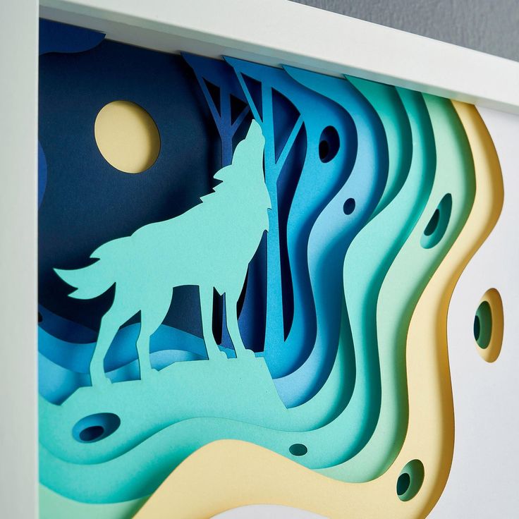 a paper cut wolf standing in the middle of a forest with moon and clouds above it