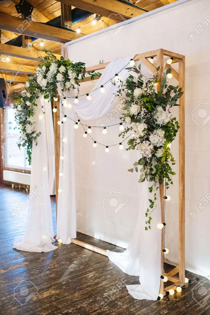 a wedding arch decorated with greenery and white flowers stock photo - 957982