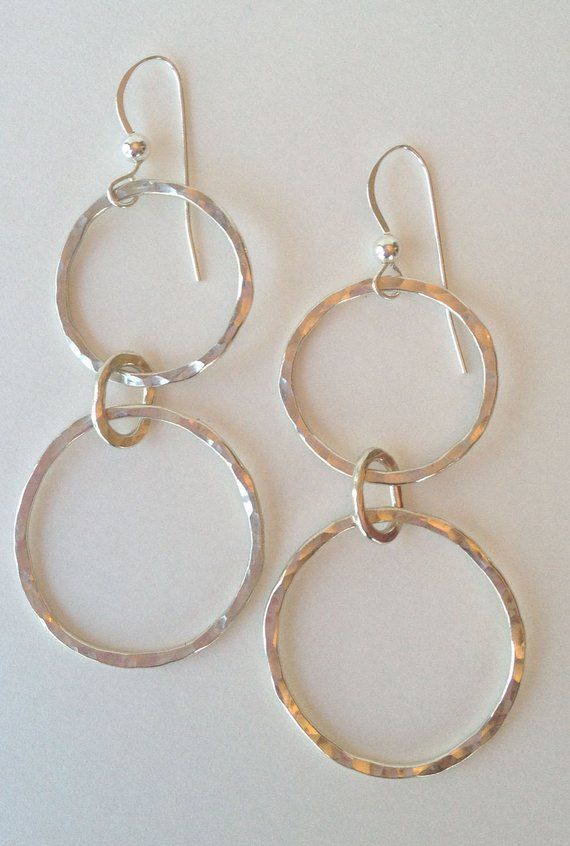 Artisan earrings with linked hand forged circlets made from 16 gauge sterling silver then hammered and polished to a high shine. These earrings measure 2 1/2 inches x 1 inch. There is also a matching necklace and matching bracelet available. Hand Forged Silver Circular Jewelry, Hand Forged Silver Circle Jewelry, Hammered Sterling Silver Jewelry, Unique Hammered Silver Jewelry, Modern Hammered Open Circle Jewelry, Unique Silver Hammered Jewelry, Hand Forged Silver Jewelry, Hammered Metal Circle Jewelry, Modern Hand Forged Open Circle Jewelry