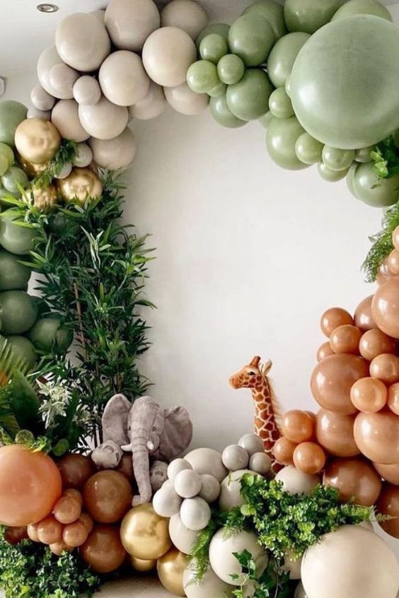 the balloon arch is decorated with balloons and jungle animals