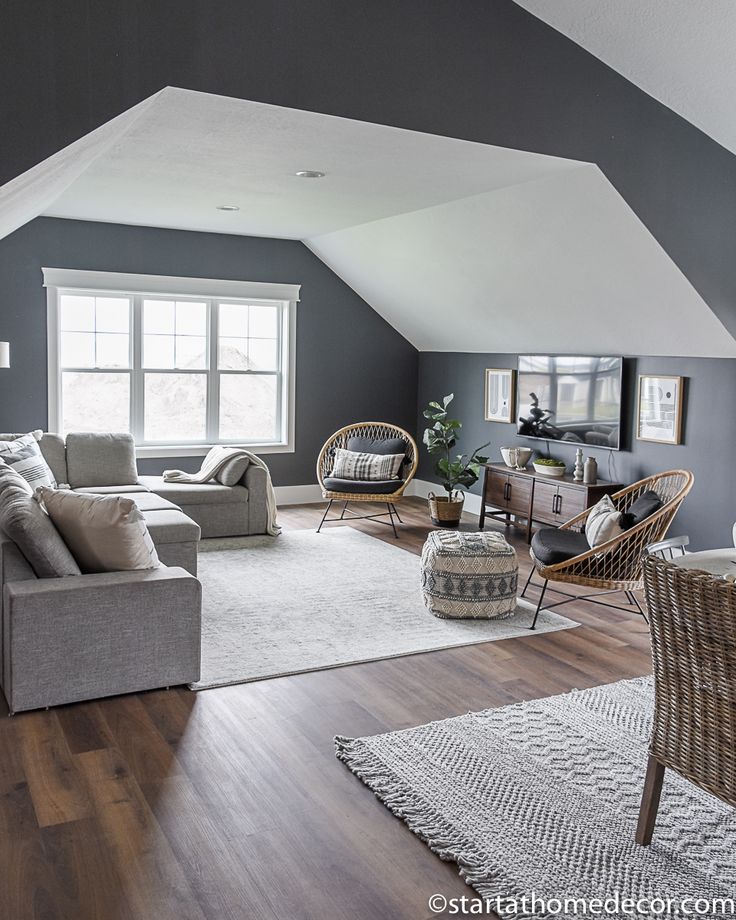 a living room filled with lots of furniture and decor on top of a hard wood floor