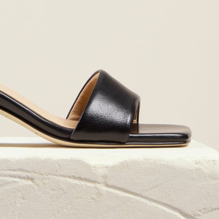 The mid-height Chaise Mules are designed with a flattering asymmetric leather toe strap and a smooth, curved block-heel. Crafted by hand in Italy, they are the epitome of easy elegance and will instantly elevate any look. Calf Leather Mules With Sculpted Low Heel, Classic Mules With Sculpted Low Heel, Sleek Kitten Heels With Heel Loop, Sleek Low Heel Kitten Heels With Heel Loop, Classic Mules With Contrasting Heel Counter, Classic Low Heel Mules With Padded Heel, Classic Mules With Padded Low Heel, Sleek Sandals With Almond Toe And Deep Heel Cup, Sleek Sandals With Sculpted Heel And Almond Toe