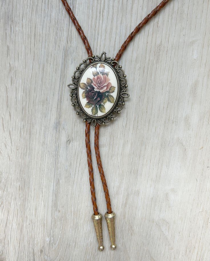 This awesome bolo tie is handmade in our shop, it has a colorful rose cabochon and a brass metal backing and brown leather adjustable cord. Quality guaranteed, picture does not do this buckle justice! We have matching belt buckles to pair! Victorian Tattoo, Nice Belts, Bolo Ties, Beading Jewelry, Colorful Roses, Bolo Tie, Bead Jewelry, Tie Accessories, Bead Embroidery