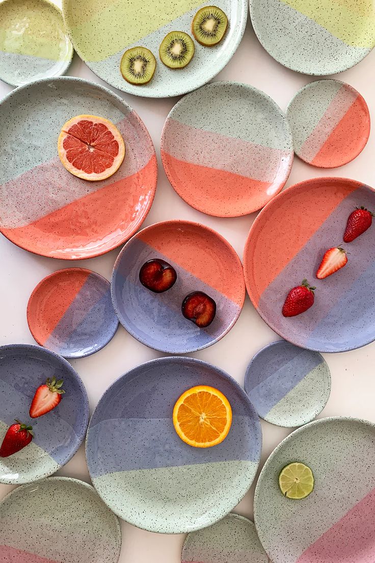 colorful plates with fruit on them are arranged in the shape of circles