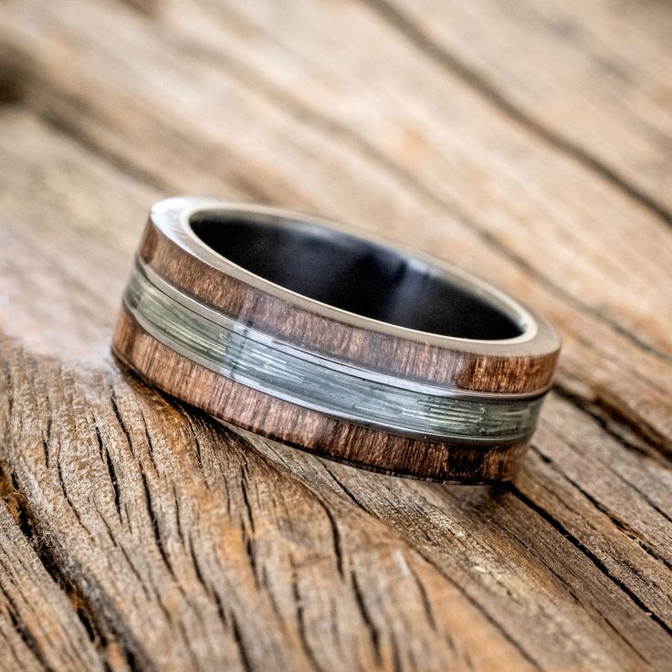 a wedding band with wood and silver inlays