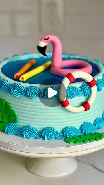 a cake decorated with an image of a flamingo and life preservers on it