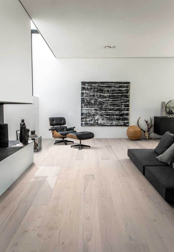 a modern living room with white walls and wood floors