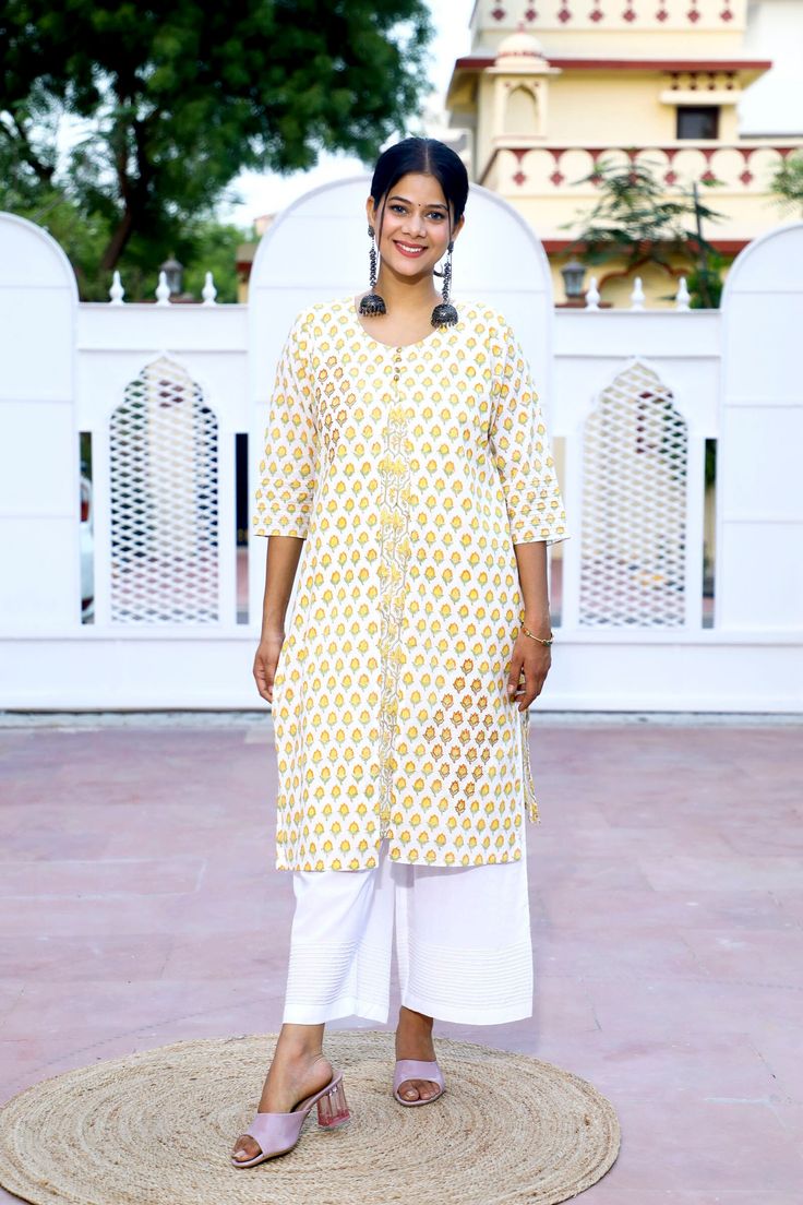 Augment your look with our yellow floral hand block print A-line premium cotton kurta set. The amber hues will give you the look of a breath of fresh air. The appealing color palette will make pose-ready for any occasion Detail: This is 2 Pc. Set Kurta set : cotton hand block printed double layered kurta set  Color : White & Yellow Composition : 100%  Cotton (Premium quality) Length : 40 Inches (Kurta).  35 Inches (Pants) Wash care :  Hand wash separately in cold water. Do not soak and scrub. Dr Yellow Mulmul Palazzo Set With Cutdana Details, Yellow Mulmul Palazzo Set With Cutdana, Yellow Straight Kurta With Printed Motifs, Yellow Traditional Wear Straight Kurta With Printed Motifs, Yellow Traditional Wear With Printed Motifs, Straight Kurta, Yellow Block Print Mulmul Sets, Yellow Anarkali Set With Straight Kurta And Printed Motifs, Yellow Anarkali Set With Printed Motifs, Yellow Printed Mulmul Palazzo Set