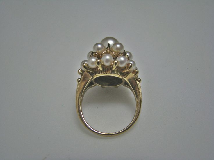 "For Sale is: (1) H077 Stunning Coctail (19) Pearl Ring in 14k Yellow Gold Please Read ENTIRE DESCRIPTION BEFORE PURCHASING This beautiful ring features cocktail ring with multiple (19) pearls in different size. Ring stamped 14k and it is size 5.5 This is a very elegant ring! Cosmetic Condition: This ring is in good condition. A few minor scratches due to age. AS SEEN IN PICTURE: Specifications: *14K Yellow Gold *Cocktail Style *Pearls (12) are approx. 3.4 mm (at the bottom of the ring) *Pearls Luxury Yellow Gold Timeless Pearl Ring, Fine Jewelry Cluster Wedding Jewelry, Gold Halo Ring With Prong Setting For Formal Occasions, Formal Gold Halo Ring With Prong Setting, Elegant Multi-stone Party Rings, Elegant Multi-stone Rings For Party, Formal Heirloom 14k Gold Halo Ring, Antique 14k Gold Pearl Ring For Anniversary, Classic Marquise Jewelry For Party