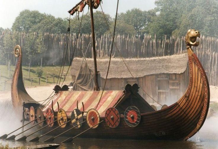 an old wooden boat is sitting in the water