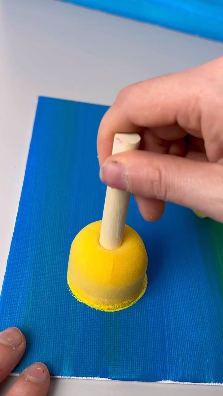 a person is using a small yellow object to make something