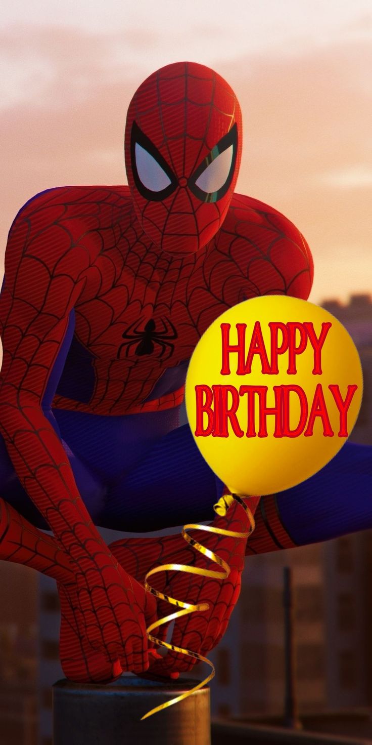 a spider man holding a happy birthday balloon