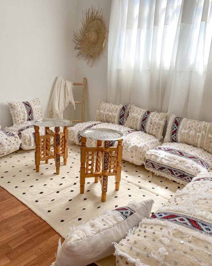 a living room filled with lots of white furniture