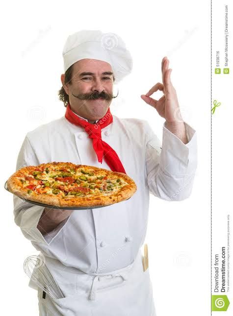 a man in an apron holding a pizza and making the peace sign with his hand