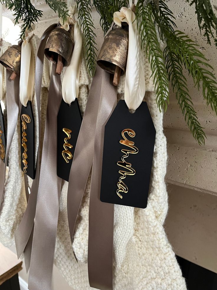 three christmas bells hanging from the ceiling with ribbons