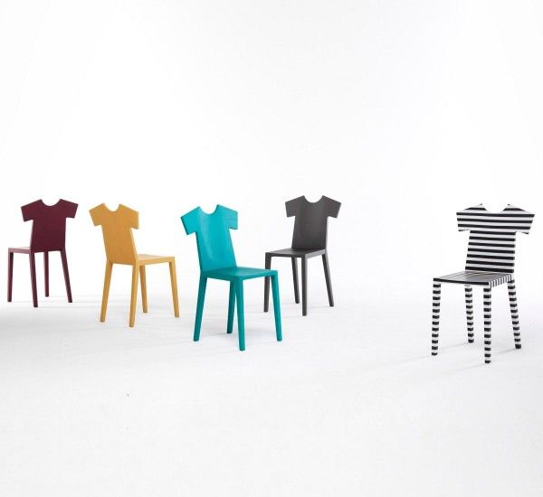 four different colored chairs with black and white stripes on the back one has a t - shirt on it