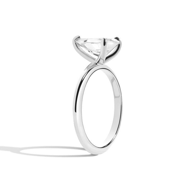 Shahla's Signature Rail-less Pear Engagement Ring is a simplistic yet modern design. This modern solitaire features a brilliant pear diamond set in four claw prongs on a soft knife-edge band. The basket has no rail, allowing full exposure of the diamond from every angle. Modern Solitaire Jewelry For Everyday, Classic White Gold Diamond Ring, Modern Platinum Rings With Vvs Clarity, Modern Moissanite Diamond Ring With Vs Clarity, Modern Platinum Diamond Ring, Modern Platinum Diamond Ring With Single Diamond, Modern Diamond Ring With Tension Setting For Everyday, Modern Everyday Diamond Ring With Tension Setting, Modern White Gold Diamond Ring With Single Diamond