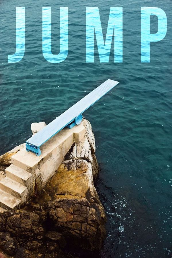 a blue bench sitting on top of a rock next to the ocean