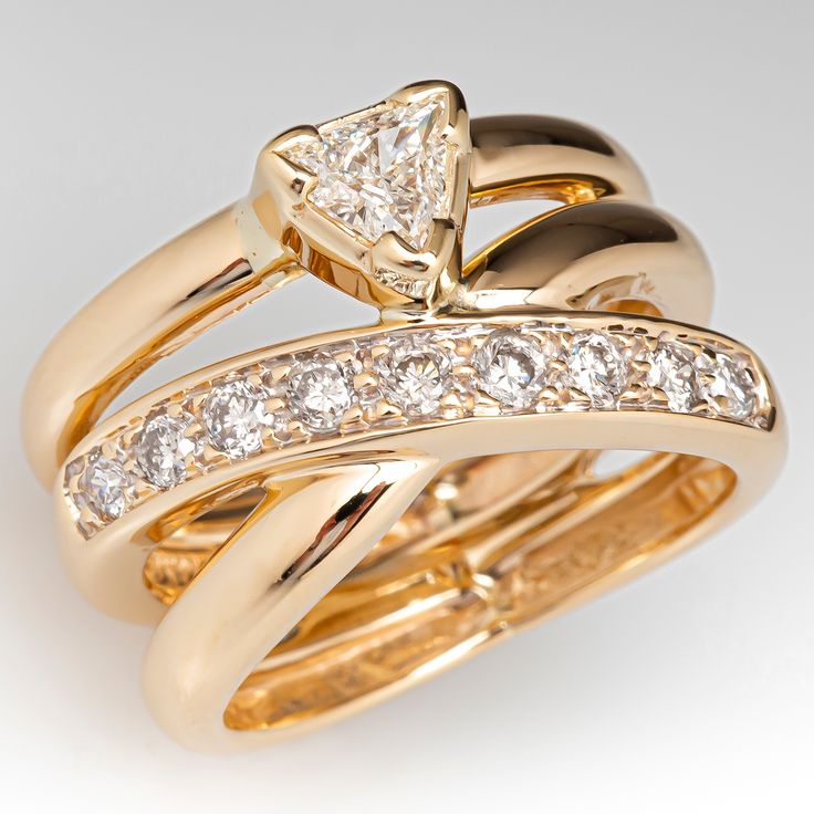 two gold wedding rings with diamonds on each one and an engagement ring in the other