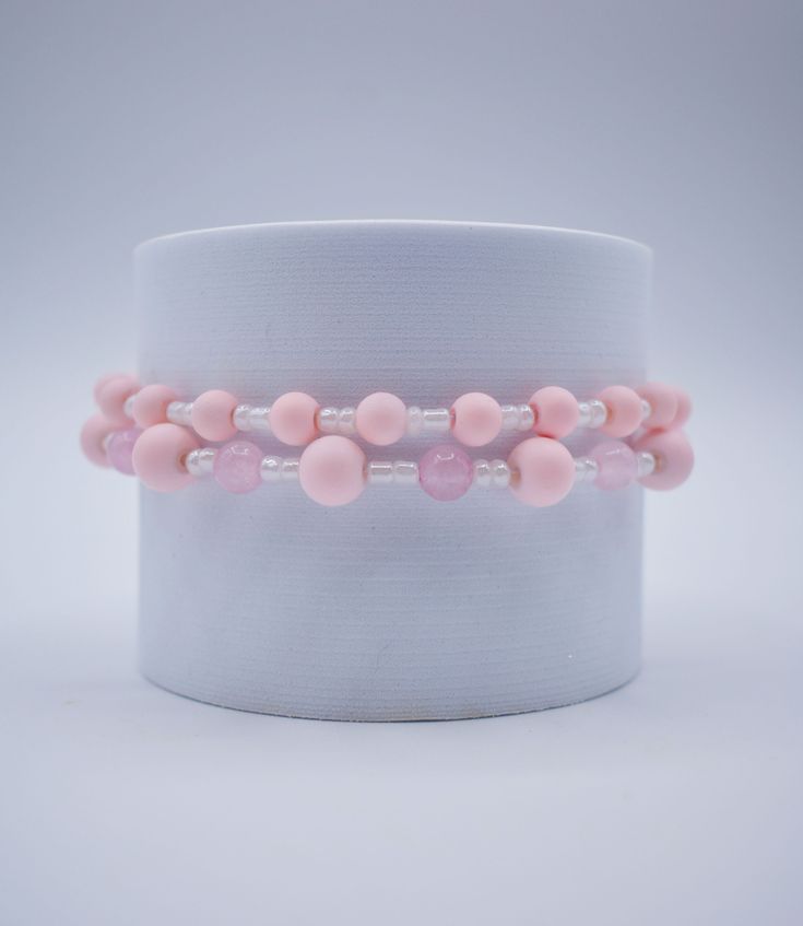 Faux baby pink pearl and glass beads make up this elastic band bracelet set! Pink Spacer Beads Bracelets For Party, Pink Party Bracelets With Spacer Beads, Pink Beaded Bracelets For Gift, Feminine Adjustable Bracelets With Round Beads, Pink Flexible Beaded Bracelets For Gifts, Pink Pearl Beaded Bracelets For Parties, Pink Beaded Stretch Bracelet For Party, Pink Beaded Party Bracelets, Adjustable Feminine Pearl Beaded Bracelets