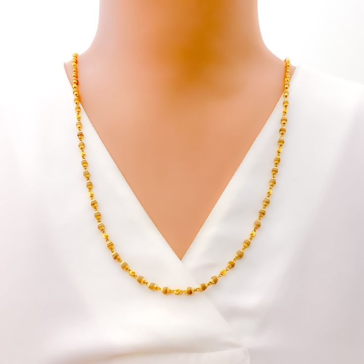 This luxurious necklace is skillfully crafted with 22k gold, totaling 11.8 grams, with 11.0 grams in gold and 0.8 grams in Tulsi beads. It showcases a radiant yellow gold finish and measures 26 inches in length, seamlessly designed without a lock for uninterrupted elegance. The subtle inclusion of Tulsi beads adds a touch of spiritual significance, making this piece not only a fashion statement but also a nod to cultural heritage. Ideal for those seeking jewelry that blends sophistication with m Traditional 22k Gold Necklace With Delicate Chain, Elegant Yellow Necklace For Puja, 22k Gold Jewelry With Delicate Chain, Elegant Yellow Gold Necklace For Puja, Gold Necklaces With Tilla Detailing In 22k Gold, 22k Gold Necklaces With Tilla Detailing, 22k Gold Necklace With Tilla, Gold Necklaces With Tilla Detailing, Gold Plated Temple Necklace With Tilla