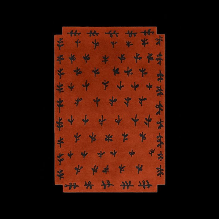 an orange and black patterned cloth with small flowers on the front, against a black background