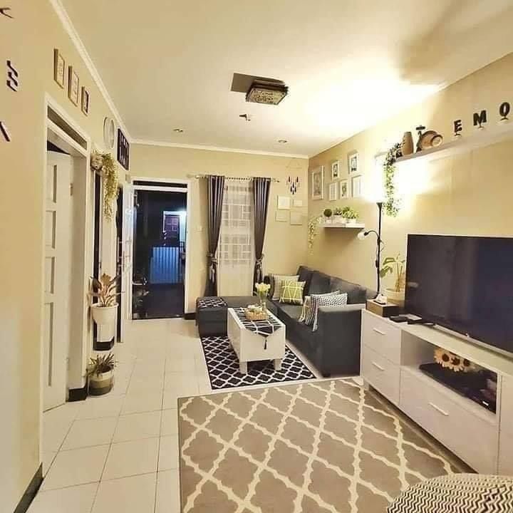 a living room filled with furniture and a flat screen tv