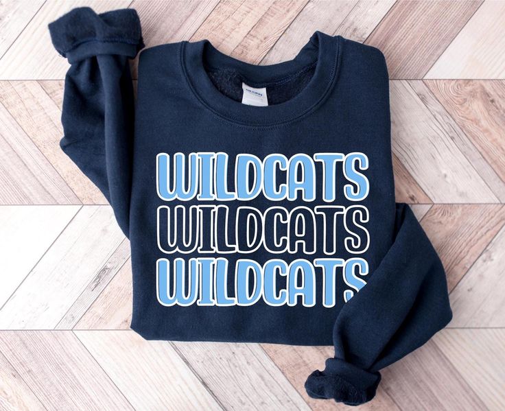 This custom team spirit sweatshirt is perfect for teachers, sports moms, students, or anyone supporting their favorite team. This cozy sweatshirt makes a great game day sweatshirt. Get one for yourself or as a gift for someone! PRODUCT DETAILS     - Gildan 18000 is heavy blend fleece crew sweatshirt     - 50% cotton, and 50% polyester     - Ribbed knit makes the collar highly elastic and helps retain its shape     - Unisex fit - please refer to the size chart in the listing photos for most accur Pre-shrunk Crew Neck Sweatshirt For School Spirit, Team-colored Long Sleeve School Spirit Sweatshirt, Team-colored Long Sleeve Sweatshirt For School Spirit, Team-colored Varsity Tops For School, Team-colored Varsity School Tops, Varsity Style Team-colored School Top, Game Day Team Spirit Sweatshirt With Lettering, College Fan Apparel Sweatshirt With Lettering, College Sweatshirt With Lettering Fan Apparel