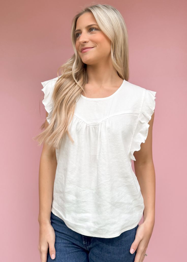 We adore simplicity and this summer top from Another Love is just that! Petal sleeve top, crew neck finished with front & back yoke & shirring, back keyhole. The Carefree urban expression of knowing & living you! Ruffle details the "down-to-earth" styling while enjoying all of life. Fit is true to size Olivia is 5'7 wearing small Size up of between sizes or for length Available in Xsmall - Large Cropped Length Not lined Pull on fit Fabric: 50% LINEN 47% RAYON 3% SPANDEX Machine wash cold, Tumble White Soft-washed Ring-spun Cotton Tops, Off-white Casual Ruffled Tops, Crew Neck Ruffled Cotton T-shirt, Crew Neck Cotton T-shirt With Ruffles, Linen V-neck Tops With Ruffles, Floral Dress Casual, Petal Sleeve, Another Love, Black Short Dress