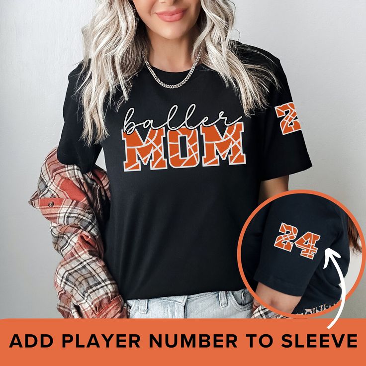 This "Baller Mom" t-shirt in black features a combination of script and decorative basketball fonts to make you stand out on game day. Add your child's number to the sleeve for an extra special touch. ✨ Premium Quality These shirts are made from high-quality, soft, breathable fabric that offers maximum comfort and durability. You'll love the way it feels against your skin.  👚 SHIRT FEATURES .: Material is 100% Airlume combed and ringspun cotton. Fiber content may vary for different colors. .: L Basketball Vinyl Shirt Ideas, Basketball Grandma Shirt Ideas, Black Number Print Top For Game Day, Senior Mom Basketball Shirts, Sporty Basketball T-shirt With Letter Print, Black Sports Tops With Number Print For Events, Mom Basketball Shirt Ideas, Black Short Sleeve T-shirt For Basketball, Black Tops With Number Print For College