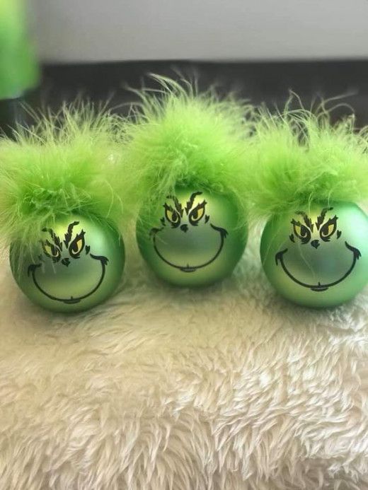 three green balls with faces painted on them