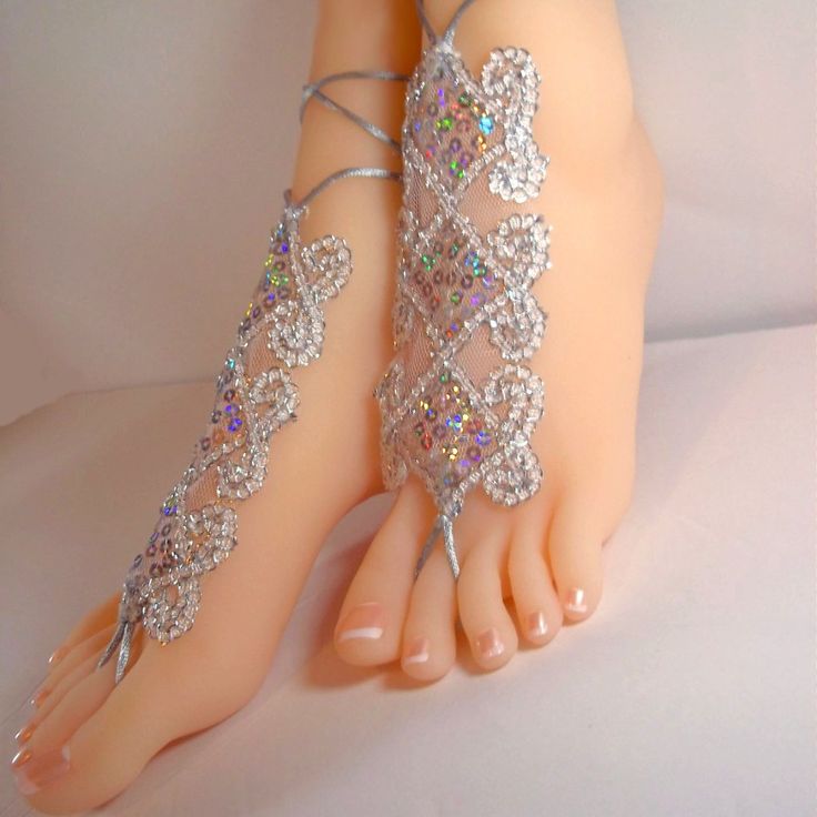 These Beautiful And Unique Barefoot Sandals Are Designed With Silver Sequins, Organza, And Silver-Colored Ties. The Sequins Form A Pretty Embroidered Triangle Design That Looks Attractive With Bare Feet Or Shoes. They Are Lightweight, Comfortable, And Tied In The Back. They Sparkle So Beautifully And Look Even Prettier In Person. A Gorgeous Style For Weddings And So Many Other Events When You Want To Look Your Best. One Size Fits Small, Medium, And Large Sizes. Adjustable Silver Sandals For Destination Wedding, Silver Ankle Strap Wedding Shoes For Summer, White Ankle Wrap Sandals For Festivals, Adjustable Closed Toe Party Sandals, Silver Anklets For Summer Destination Wedding, Silver Ankle Wrap Barefoot Sandals For Party, Elegant Barefoot Sandals For Summer Party, Silver Anklets For Destination Wedding In Summer, Silver Anklets For Destination Wedding