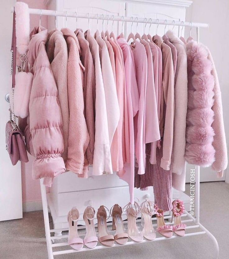 a rack filled with lots of pink clothes