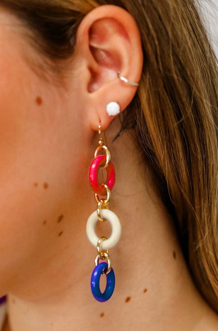 Make a statement with these unique Three Colorful Rings Earrings! Whether you want to add a pop of color to a simple outfit, or make a loud and proud fashion statement, these earrings are the perfect accessory. Add a touch of color and sparkle to your wardrobe!Details: Colorful Dangle Earrings Three Colorful Rings French Hook Ear Wire for Pierced Ears Approximate Dimensions: Length: 3.5" Rings: 0.75" DiameterRed, White and Blue ComboPink, Yellow and Purple Combo Chic Multicolor Summer Jewelry, Playful Jewelry Set With Drop Earrings, Playful Jewelry Set With Matching Drop Earrings, Trendy Colorful Dangle Hoop Earrings, Trendy Multicolor Single Earring, Chic Multicolor Metal Jewelry, Bold Jewelry With Matching Dangle Earrings, Colorful Round Trendy Earrings, Trendy Colorful Earrings