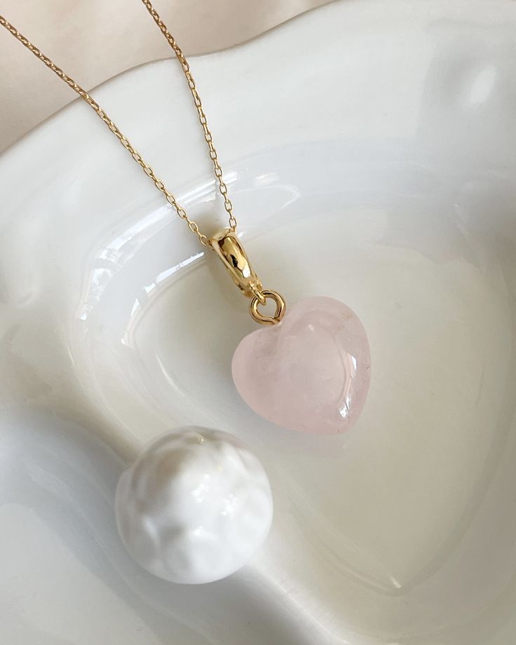 Wear your heart on your neckline with our Rose Quart Heart Necklace. Let this beautiful rose quart stone promote love, harmony, and inner healing.  Rose quartz Heart 15mm Gold filled chain 16 inches All items come in a gift box ready to gift. To see more please visit  https://www.etsy.com/shop/BijouLimon Bijou Limon jewelry collections present a romantic French spin on the latest jewelry trends. Based on the US West Coast but French at heart, Bijou Limon interprets the current jewelry trends and Rose Quartz Heart Necklace, Valentine's Day Crystal Necklace With Heart Pendant And Charm, Heart-shaped Gemstone Heart Necklace For Weddings, Heart Shaped Crystal Necklace For Valentine's Day Anniversary, Heart-shaped Crystal Necklace For Valentine's Day Anniversary, Heart-shaped Gemstone Necklace For Wedding, Valentine's Day Heart Pendant Crystal Necklace With Heart Charm, Valentine's Day Heart Charm Crystal Necklaces, Pink Open Heart Necklace For Weddings