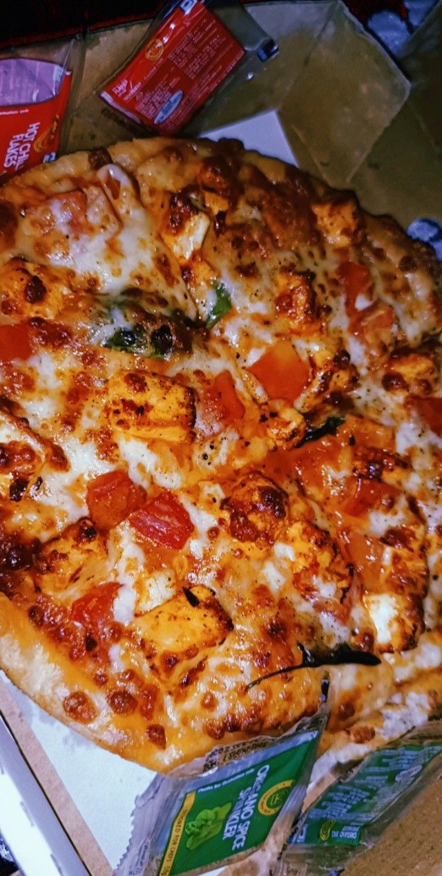 a pizza sitting on top of a cardboard box